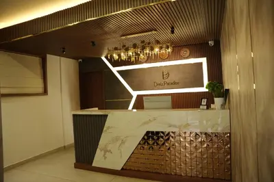 a bar in a restaurant with a sign on the wall at Denz Paradise in Kelakam