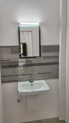 a bathroom with a sink and a mirror at Voyagers Nest Wayanad in Ambalavayal