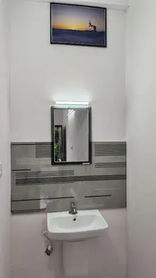 a bathroom with a sink and a mirror on the wall at Voyagers Nest Wayanad in Ambalavayal