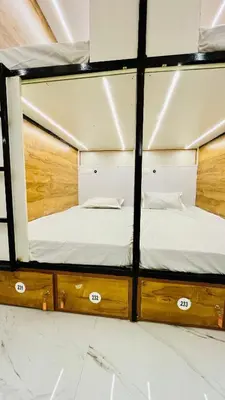 a room with two bunk beds and a mirror at LF Hotels in Kozhikode