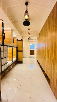 a large hallway with a large marble floor and wooden walls at LF Hotels in Kozhikode