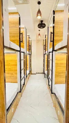 a row of bunk beds in a room with a hallway at LF Hotels in Kozhikode