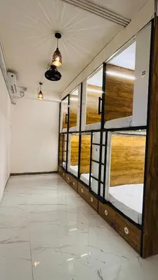 an empty room with glass doors and windows at LF Hotels in Kozhikode