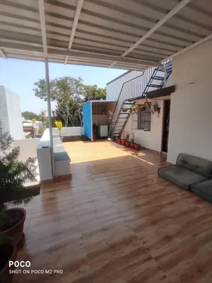 a living room with a staircase in a house at Sumukh's house in Mysore