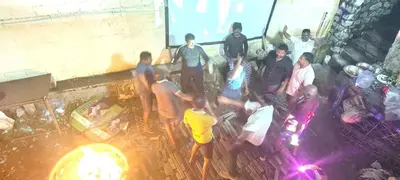 a group of people standing in front of a fire at HILL view ooty HOME Stay in Coimbatore