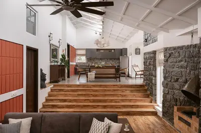 a living room with a ceiling fan and a dining room at Hillside Home 3 BHK Villa by tisyastays in Yedapalli