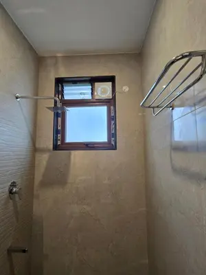 a bathroom with a shower and a window and a shower at Indhraprashtham in Aruvankadu