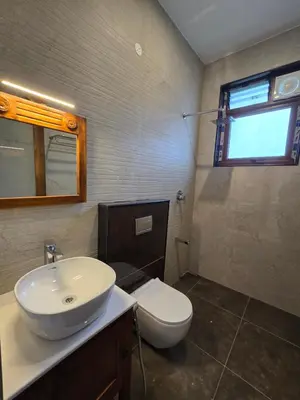 a bathroom with a sink and a toilet at Indhraprashtham in Aruvankadu