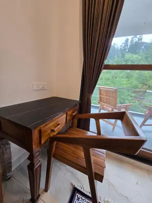 a ping pong table in a room with a window at Indhraprashtham in Aruvankadu