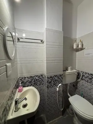 a bathroom with a sink and a toilet at SKYRIN Bliss in Mysore