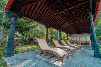 a row of chairs sitting under a pavilion at Madilina Heritage Villa in Parūr