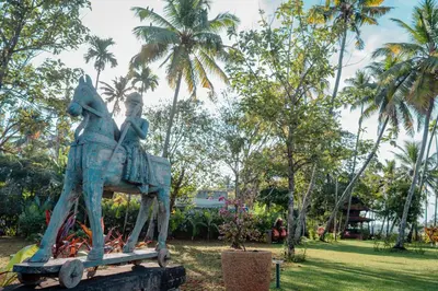 a statue of a person riding a horse in a park at Madilina Heritage Villa in Parūr