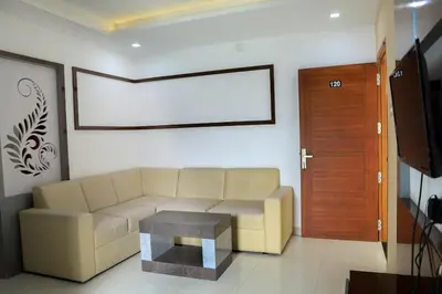 a living room with a couch and a table at Ambalath whitespring in Guruvāyūr