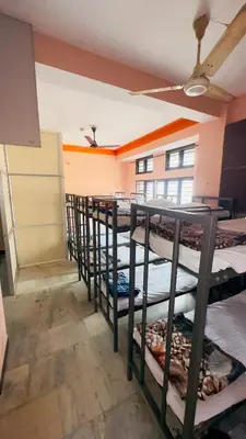 a row of bunk beds in a room at SGH Mysore dorm bus rail station in Mysore