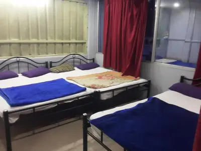 a group of three beds in a room at SGH Mysore dorm bus rail station in Mysore