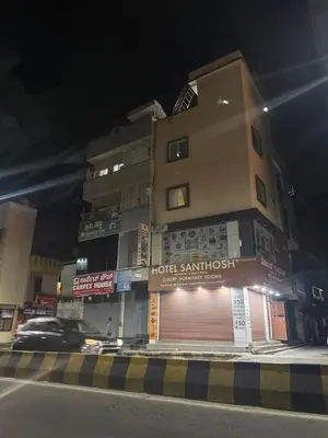 a building on a street at night at SGH Mysore dorm bus rail station in Mysore