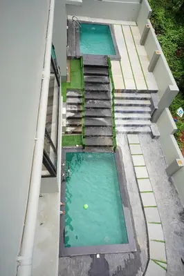 an overhead view of two swimming pools on a building at LA VILLA Resort in Vythiri