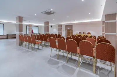 a row of chairs in a conference room at Hotel Golden Couch in Badagara