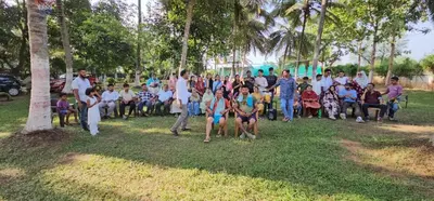 a group of people standing around in a park at Lucky Escape Adda in Hullahalli