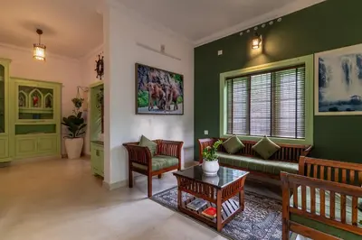 a living room with a couch and a table at GEE DE Homes in Kizhake Chālakudi
