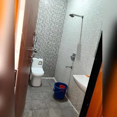 a small bathroom with a toilet and a sink at LUXE Premium Service Appartment in Mysore