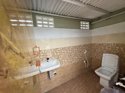 a bathroom with a sink and a toilet at JMS Holiday homes in Coonoor