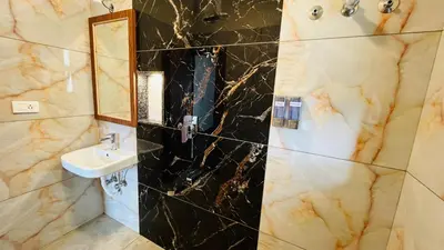 a bathroom with a sink and a mirror at Away From Home - 9 - HomeStay, Entire 2 BHK Villa in Ooty