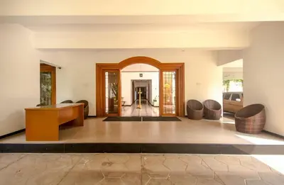 a living room with a table and chairs at Dwaraka inn -Premium Pool villa and event venue in Coimbatore