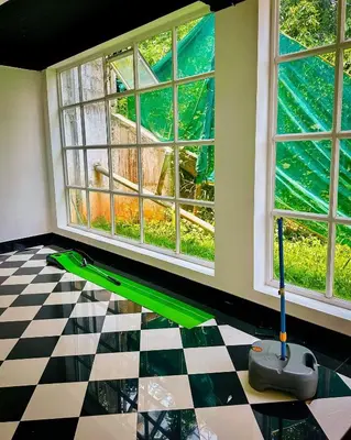 a room with a mop on the floor next to windows at Aura 2Bedroom Duplex Villa with infinity pool in Kalpetta