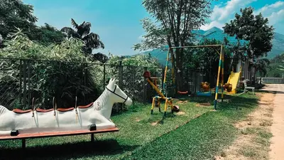 a playground with a white horse on a bench at Aura 2Bedroom Duplex Villa with infinity pool in Kalpetta