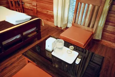 a room with a bed and a table and a chair at Wood Clusters in Suntikoppa