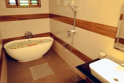 a bathroom with a tub and a sink at Wood Clusters in Suntikoppa