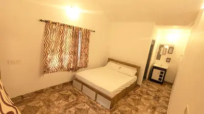 a small bedroom with a bed and a window at Lush Lagoon Homestay in Ambalavayal