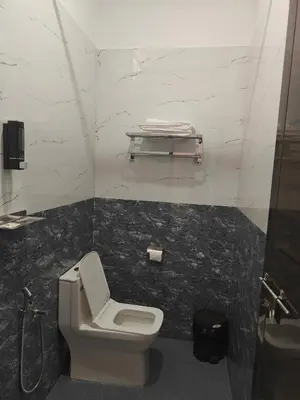 a bathroom with a toilet and a sink at AppleLand City Athirapilly by Hotels Cart in Athirappally