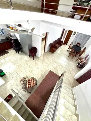 an overhead view of a living room with chairs and a table at Pavans Rainy Days Home Stay in Athirappilly