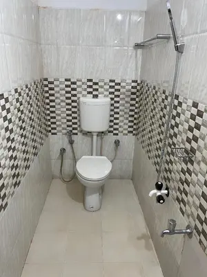 a bathroom with a toilet and a shower at Wayanad Midnight Farmhouse in Sultan Bathery