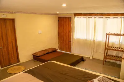 a small room with two beds and a window at Nirvana 'By the lake' in Kūkkāl
