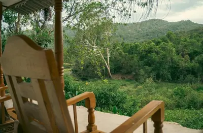 a chair sitting on a porch with a view of a mountain at Nirvana 'By the lake' in Kūkkāl
