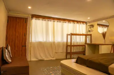 a bedroom with a bed and a window at Nirvana 'By the lake' in Kūkkāl