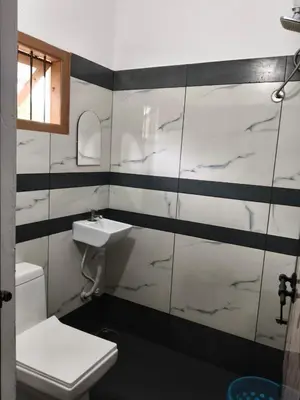 a bathroom with a sink and a toilet at Palm view 2 in Kanthalloor