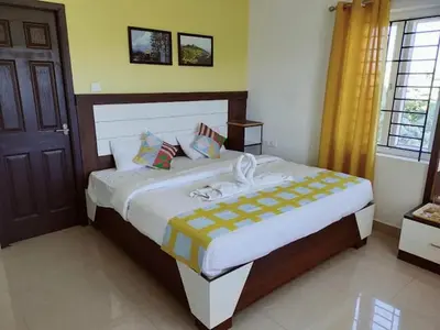 a bedroom with a large bed in a room at Hill Grove By Brown Tree Resorts in Ooty