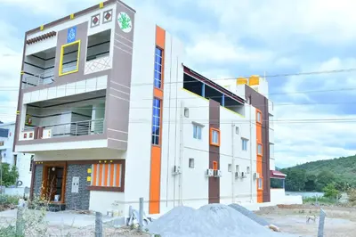a building with orange and white at CS RESORT River point in Wodapatti