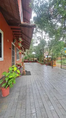 an outdoor patio with plants and a building at Kadavath Homestay in Ernakulam