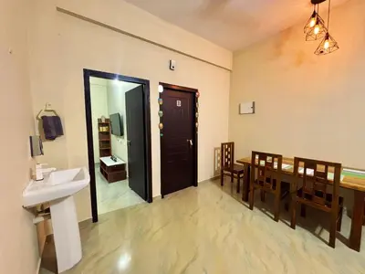 a dining room with a table and a sink at Saraa Homes Fully Furnished 2BHK Apartment in Kulattūr