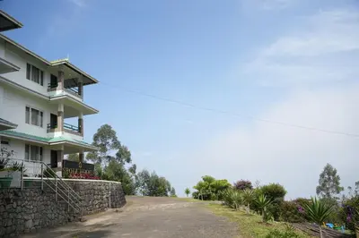 a house on the side of a road at Shola Heaven Resort in Kanthalloor