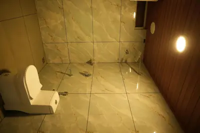 a bathroom with a toilet and a shower at Shola Heaven Resort in Kanthalloor
