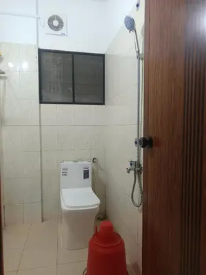 a bathroom with a toilet and a shower at Poonthanam guest house in Guruvāyūr