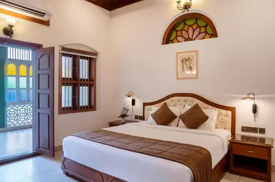 a bedroom with a bed and a stained glass window at Villa de 1945 in Mahe