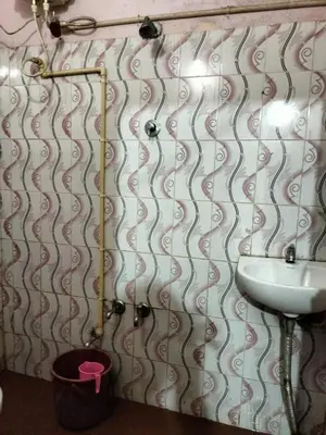 a bathroom with a sink and a toilet at Laharya couple room in Madikeri