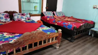 a room with two beds and a bed sidx sidx sidx at Laharya couple room in Madikeri